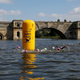 A swimming competition held in the lake, with the Grand Bridge behind.